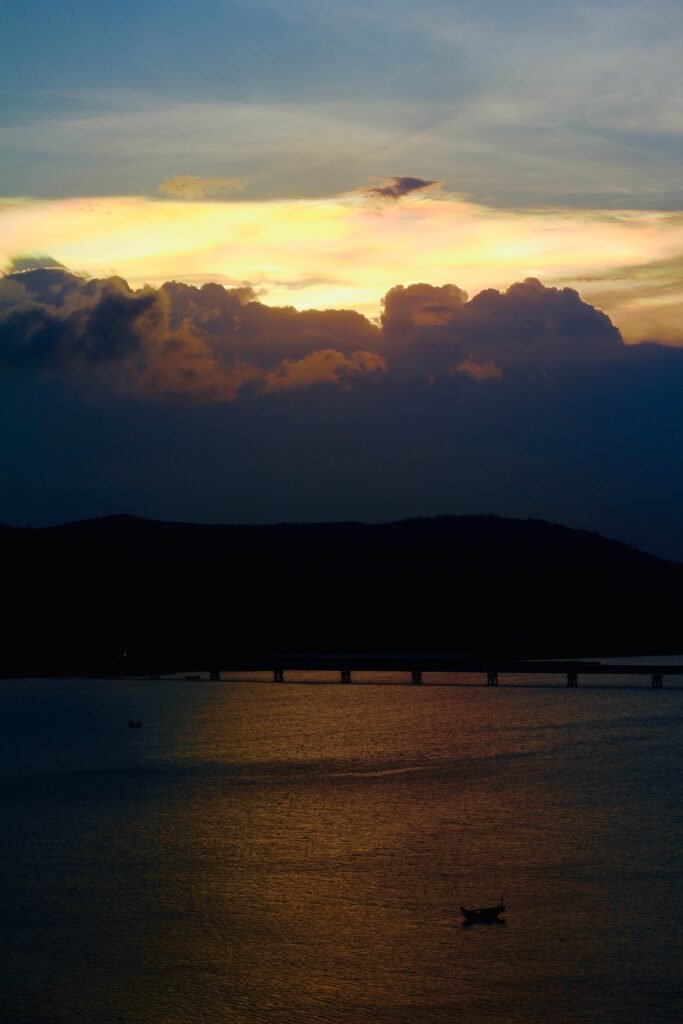 a large body of water under a cloudy sky